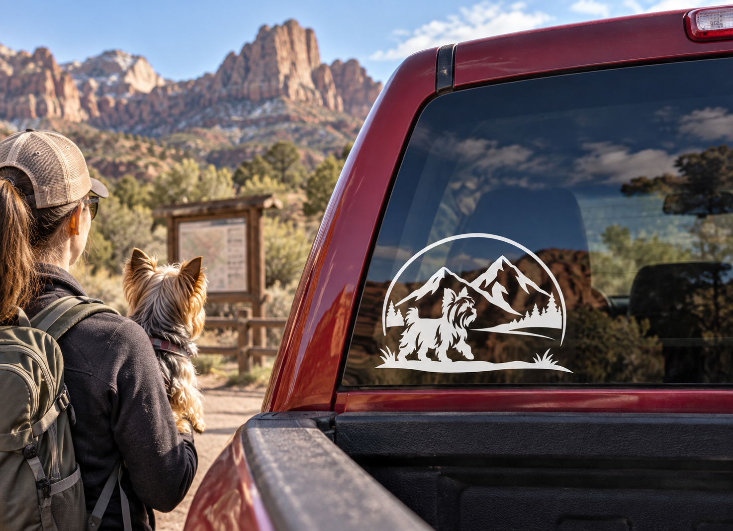 Yorkshire terrier vinyl decal inside a mountain landscape circle on a truck window