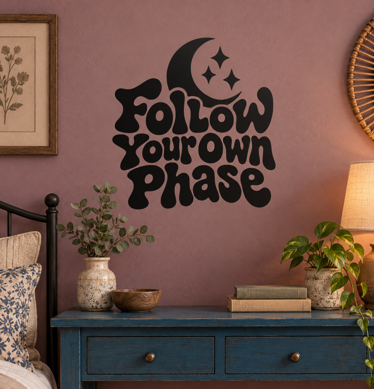 Black vinyl decal with crescent moon, stars, and drippy stylized lettering on wall