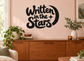 Black vinyl wall decal reading "Written in the Stars" with moon and star