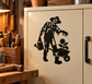 Black zombie gardening vinyl decal with wheelbarrow and spade, on a cabinet door