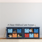 Wall decal text "A Happy Childhood Lasts Forever" in black script.