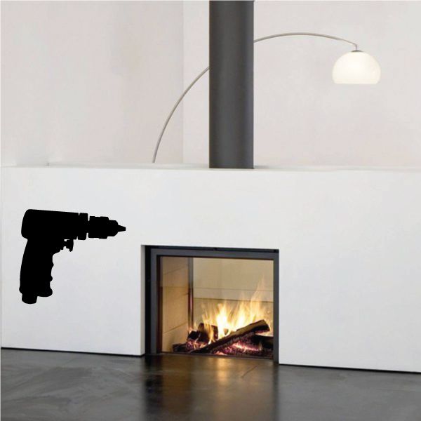Air powered drill decal, black drill silhouette on light wall near fireplace opening