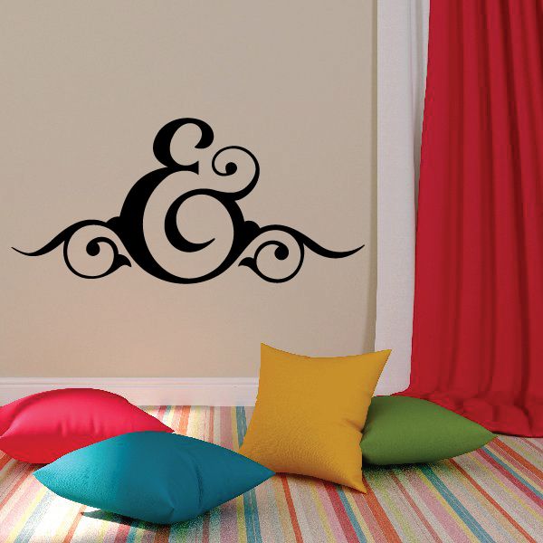 Black vinyl wall decal featuring a decorative ampersand-like symbol with scrolls