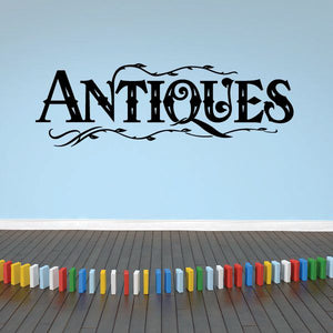 Antiques vinyl wall decal with ornate uppercase lettering in dark ink