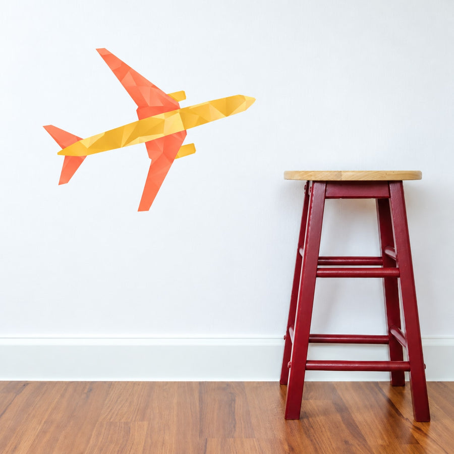 Colorful airplane vinyl wall decal with orange and yellow geometric design