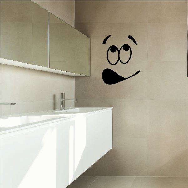 Toilet face decal with black cartoon smiling eyes and nose on wall
