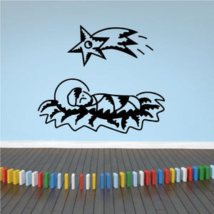 Nativity wall decal of a baby figure lying in a manger with a star and rays