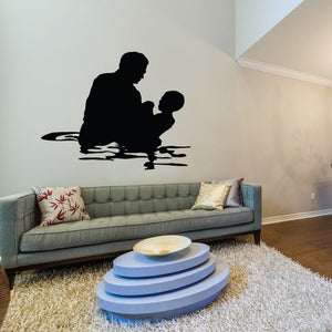 Baptism decal with black silhouette of a woman and child kneeling