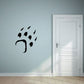 Bear paw imprint wall decal with scattered paw prints, black finish
