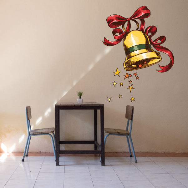 Christmas bell sticker with golden bell, red ribbon, and falling star accents