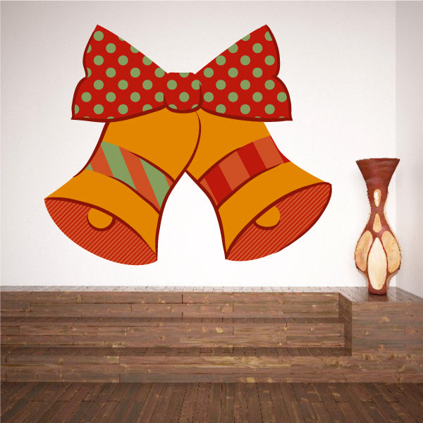 Orange bell pair sticker with red polka-dot bow and striped bell faces