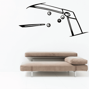 Corner table with billiards balls decal: black pool cue and ball graphic above beige sofa
