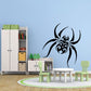 Black spider wall decal with skull motif and decorative blade-like legs.