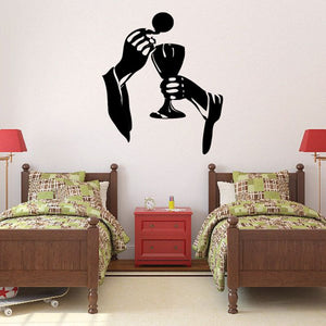 Religious wall decal of praying figure holding chalice and wafer