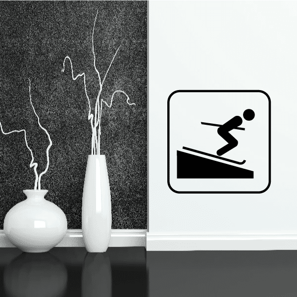 Skier sign decal: black bombing skier icon in a rounded square frame