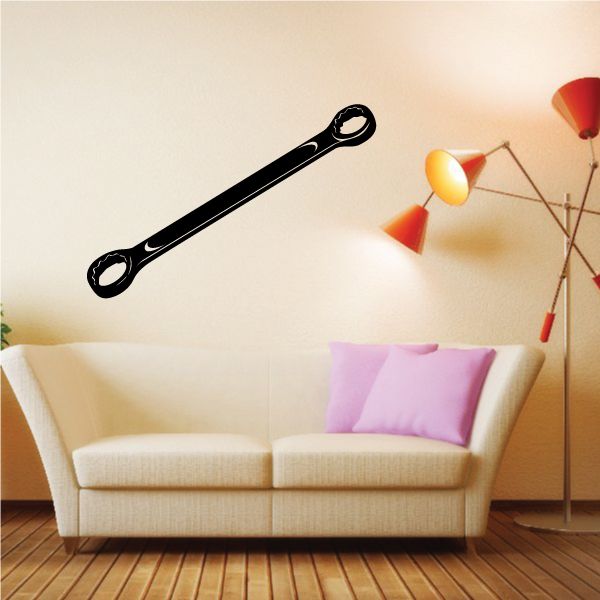Black double box-end wrench decal with two enclosed ring ends on a light wall