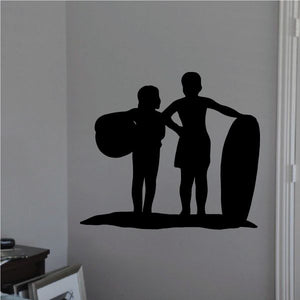 Boy and girl surfing decal with two dark silhouette surfers and surfboards