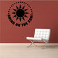 Sun wall decal with black rays and text “BRING ON THE SUN”