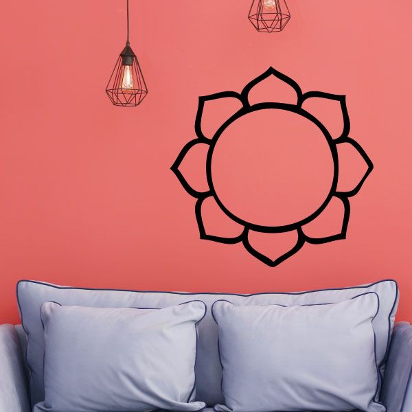 Black lotus flower decal with circular center on light pink wall