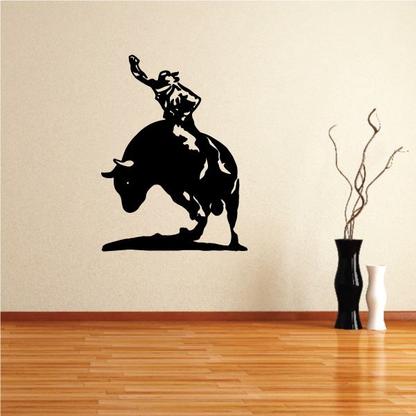 Bull riding vinyl wall decal with black silhouette of rider on bull