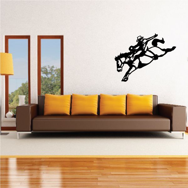 Bull riding wall decal: black silhouette of cowboy on charging bull