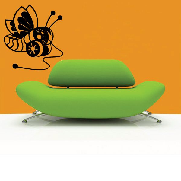 Black butterfly wall decal with curled antennae and small dot accents