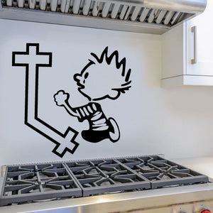 Black vinyl wall decal of cartoon animal reaching a large cross and small heart