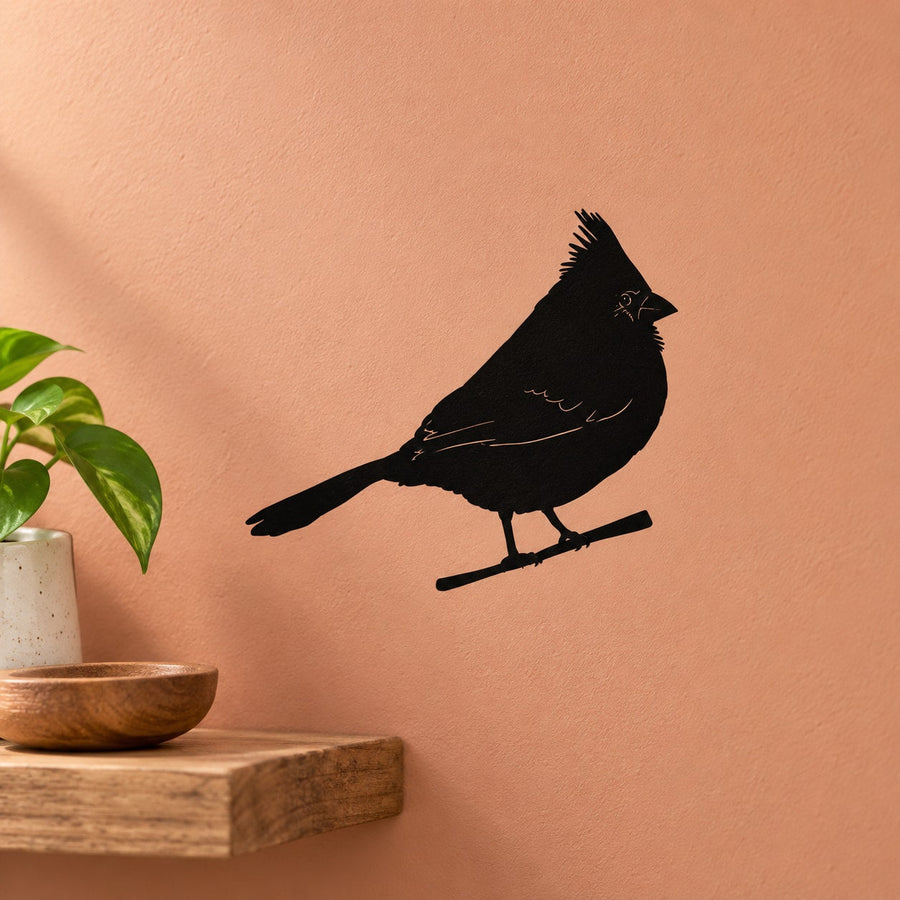 Perched bird decal featuring a black bird silhouette sitting on a small branch perch