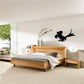 Black cartoon parrot silhouette wall decal with wings spread and tail feathers