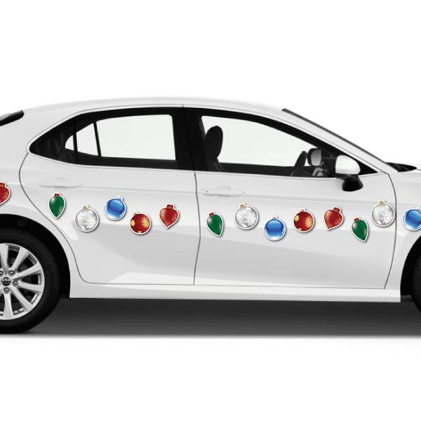 Christmas ornament magnets on white car door—red, green, blue and silver hanging shapes