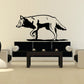 Black-and-white wolf decal, side view running across a flat silhouette.