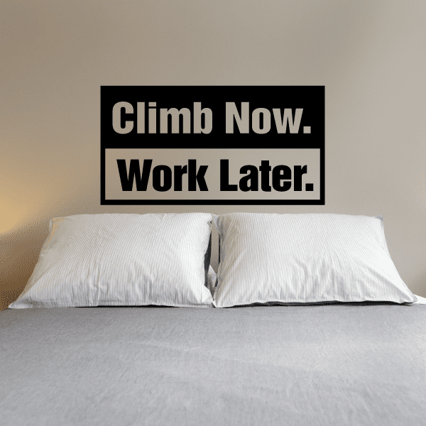 Black rectangular wall decal that reads "Climb Now. Work Later."