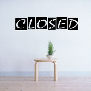 Black closed vinyl wall decal with stylized lowercase lettering