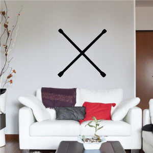Crossed black wrench decal on a light wall above a sofa