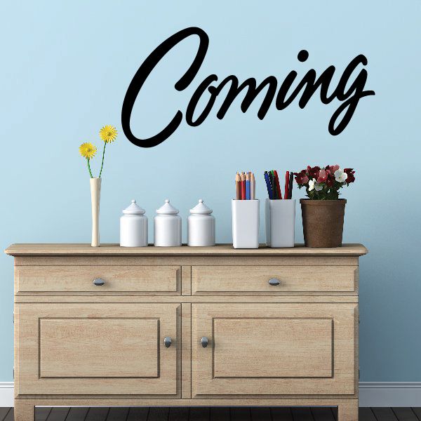 Black vinyl script 'Coming' wall decal