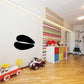 Cow track decal with two black paw prints on a wall