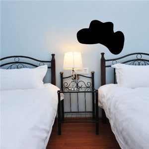 Black cowboy hat wall vinyl decal, flat silhouette above bed headboard