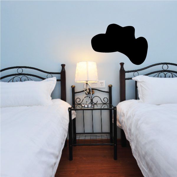 Black cowboy hat wall vinyl decal, flat silhouette above bed headboard