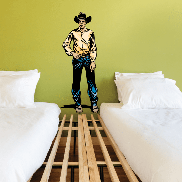 Cowboy sticker with cream long-sleeve shirt, hands at belt, wearing a black hat