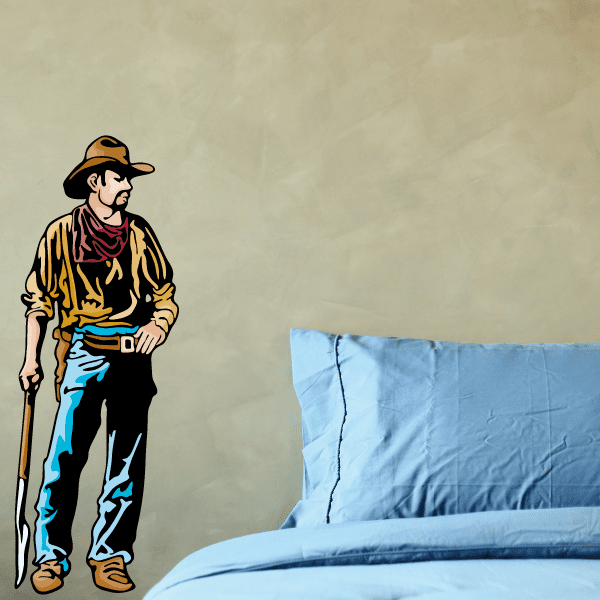 Illustrated cowboy sticker in tan shirt, hat, and beard with hand at belt