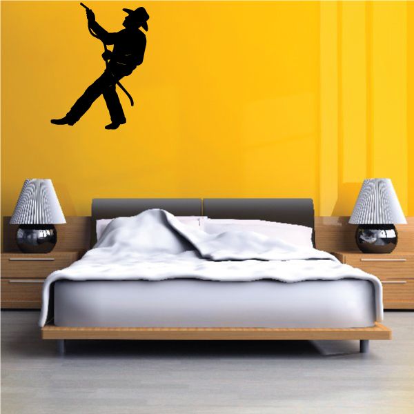 Cowboy wall decal vinyl of black cowboy silhouette on yellow wall