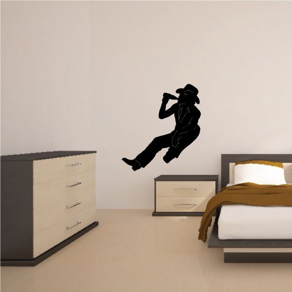 Cowboy wall decal of black silhouetted rider holding a hat