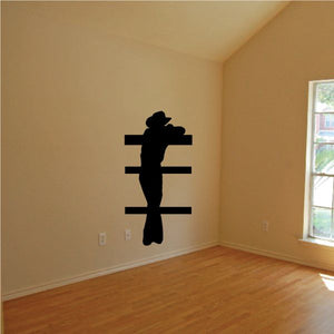 Black cowboy silhouette wall decal with horizontal stripes behind