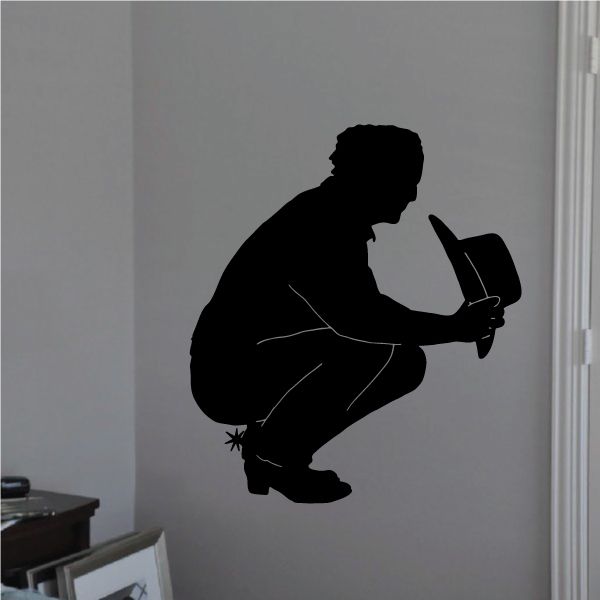 Cowboy wall decal silhouette of a kneeling cowboy holding a hat