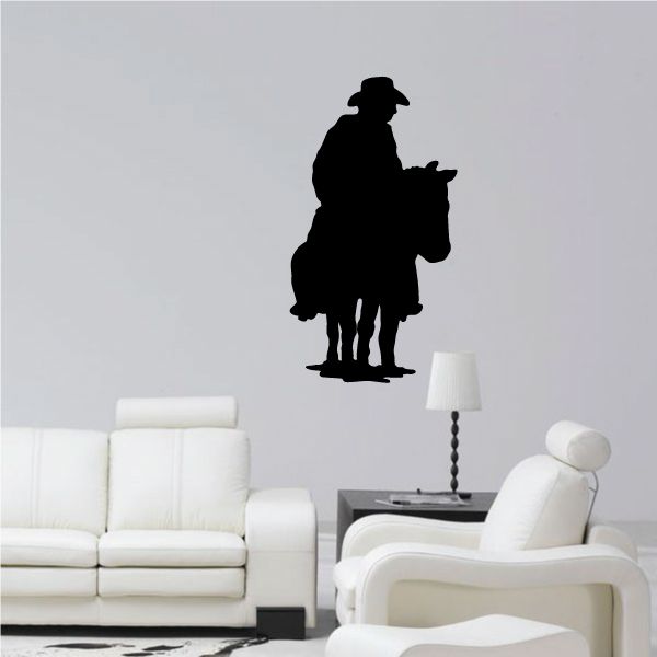 Cowboy wall decal featuring a black silhouette of a standing cowboy with hat