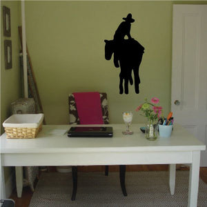 Black cowboy silhouette wall decal with hat and raised arm