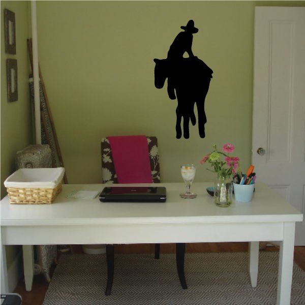 Black cowboy silhouette wall decal with hat and raised arm