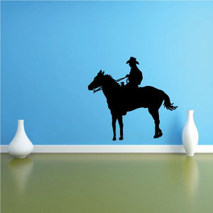 Cowboy silhouette wall decal: rider on black horse, vinyl graphic.