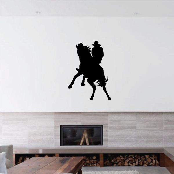 Cowboy vinyl wall decal showing a black cowboy riding a horse silhouette