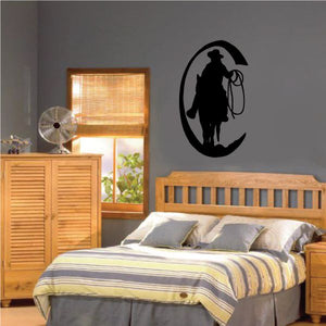 Black cowboy silhouette wall vinyl decal with hat and lasso in circular moon shape